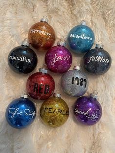 six christmas ornaments with the names of different people in them on a white furnishing