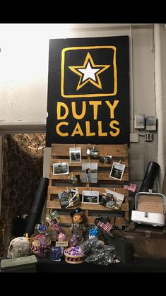 there is a sign that says duty calls with pictures and other items on display in front of it