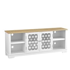 a white entertainment center with wooden top and laser cutouts on the doors, in front of a white background