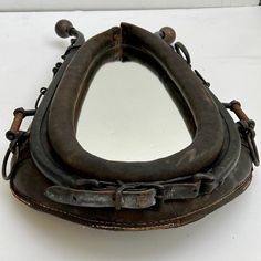 an old baseball catchers mitt sitting on top of a white table next to a mirror