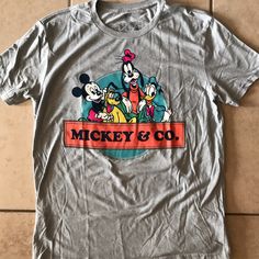 New Without Tags Disney’s Mickey & Co Short Sleeve T-Shirt 50% Cotton 50% Recycled Polyester Mickey Mouse Crew Neck T-shirt For Disney Events, Disney Pre-shrunk Short Sleeve T-shirt, Disney Character Print Cotton T-shirt, Disney Short Sleeve Pre-shrunk T-shirt, Disney Short Sleeve Letter Print T-shirt, Disney Short Sleeve T-shirt With Letter Print, Graphic Tee T-shirt For Disney Fan Events, Disney Themed Cotton T-shirt, Fun Letter Print T-shirt For Disney Fan Events