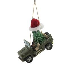 a christmas ornament hanging from the ceiling with a toy jeep carrying a tree