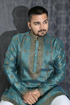 Revamp your festive wardrobe with our Embroidery Kurta Pyjama Set for Men. Designed in rich and regal Silk, this attractive readymade attire sports delicate sequins embroidery across its expanse, sure to catch the eyes at any reception. Available for chest sizes from 26 to 40. It comes complete with a Chudidar bottom in classic white, complementing the resplendent silk Kurta in an effortlessly chic manner. Embroidery Kurta, Men Kurta, Kurta Pyjama, Silk Kurta, Festive Wear, Sequins Embroidery, Green Art, Pyjama Set, Sea Green