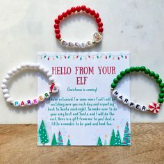 two bracelets with the words hello from your elf on them and a card that says hello from your elf