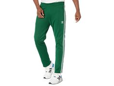 adidas Originals Beckenbauer Track Pants - Men's Clothing : Dark Green : You don't need to be on the track to enjoy the adidas Originals Beckenbauer Primeblue Track Pants. Settle into the comfort of these classic pants and go at your own speed. This product is made with Primeblue, a high-performance recycled material made in part with Parley Ocean Plastic. Super heavyweight fabric. Regular fit is not tight and not loose, the perfect in-between fit. Drawcord on elastic waist. Center seam detail a Adidas Athleisure Sweatpants For Workout, Athleisure Jogging Bottoms With Three Stripes Branding, Athleisure Joggers With Three Stripes Branding For Training, Green Sportswear Bottoms With Three Stripes, Athleisure Jogging Bottoms With Three Stripes, Athleisure Sweatpants With Three Stripes For Training, Athleisure Bottoms With Three Stripes For Jogging, Green Athleisure Bottoms With Side Stripes, Adidas Logo Athleisure Sweatpants For Gym