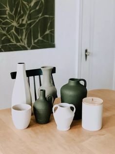 several vases sitting on top of a wooden table