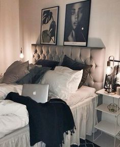 a bedroom with a bed, nightstands and pictures on the wall above it's headboard