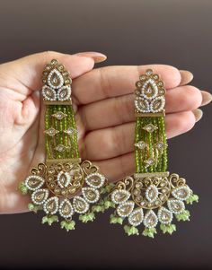 Statement earrings for a statement look! These handmade high quality kundan beaded and meenakari earrings in stunning olive green and gold are a unique addition to your outfit to glam it up! These earings can be paired with both Indian and western outfits. They are also extremely lightweight because they are handcrafted. Easy on your ears and beautiful for the eyes 💖 For any queries, please reach out to us. Happy shopping! Meenakari Earrings, Dangler Earrings, Pakistani Wedding, Ear Jewelry, Western Outfits, Long Earrings, Diwali, Green And Gold, Wedding Bridal