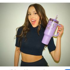 a woman holding up a purple cup with stars on it and the caption says, i am not sure what this is