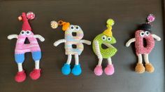 three crocheted toy figures sitting next to each other