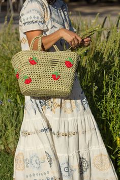 Introducing our Woven Straw Beach Basket, a versatile must-have for your sunny getaway! Inspired by the classic French style shopping basket, this eco-friendly gem is handcrafted from natural fibres, ensuring its durability while keeping sustainability at the forefront. The intricate crochet details add a touch of elegance to this timeless piece, making it ideal for both beach trips and shopping sprees. Its spacious interior offers ample room for all your essentials, while the sturdy handles provide comfort and ease while carrying. Embrace the charm of this woven straw beach basket and let it be your trusted companion for all your adventures. Description: Basket of natural fibre, hand-woven by Argentinian artisans. It has crochet-woven fruits applied all around the basket. Three options: s Natural Handwoven Straw Bag For Summer Outings, Woven Crochet Bag For Spring Picnic, Natural Straw Bag For Summer Outings, Woven Jute Straw Bag For Summer Outings, Eco-friendly Handwoven Straw Bag For Vacation, Handwoven Straw Bag For Beach Season, Eco-friendly Woven Straw Bag For Summer Outings, Eco-friendly Beach Bag For Spring Picnic, Eco-friendly Beach Bag For Spring Picnics