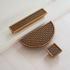 two pieces of brown woven material sitting on top of a white counter