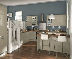 a kitchen with blue walls and wooden floors