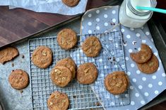 chocolate chip cookies cooling on a cookie sheet with a glass of milk