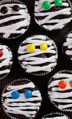 cupcakes decorated with white icing and colorful candies are displayed on the instagram page