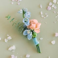 a bouquet of flowers sitting on top of a table covered in confetti flakes