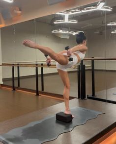 a woman doing yoga on top of a mat