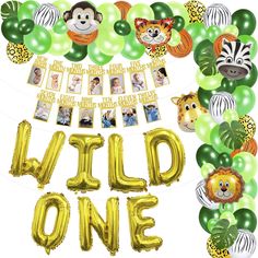 the wild one banner is surrounded by balloons and jungle animals, including giraffes