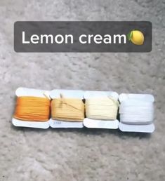 four skeins of lemon cream sitting on the floor