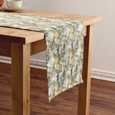 a wooden table topped with a bowl of fruit