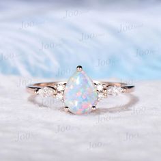 1.25ct Pear Shaped Opal Engagement Ring Vintage Rose Gold October Birthstone Wedding Ring Teardrop White Opal Ring Anniversary Birthday Gift Accept engrave the words inside the ring service: https://www.etsy.com/listing/1103764936/engrave-service Engagement Ring: 6*8mm pear cut lab opal The side stones are Simulated Diamonds Material Metal: 925 sterling silver, Solid 10k/14k/18k gold,platinum This jewelry is made to order, it can be made with any gemstone/metals. 2-3 weeks to finish. Default Shipping method is usps. 30 days non-hassle return policy.For returned items,there may be handcrafting and shipping fee deducted. Pear Shape Opal Engagement Ring, Teardrop Opal Ring, Wedding Ring Teardrop, Pear Opal Ring, Opal Engagement Ring Vintage, Birthstone Wedding Ring, Opal Birthstone Ring, White Opal Engagement Ring, Wedding Rings Teardrop