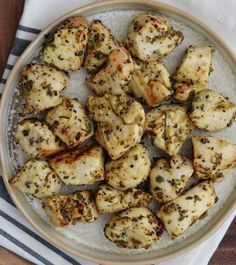 a white plate topped with chicken pieces covered in seasoning