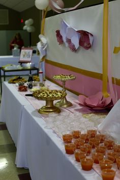 the table is set up with candles and desserts