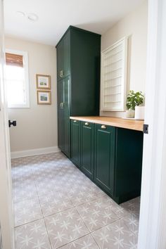 the kitchen is clean and ready for us to use it's green cabinetry