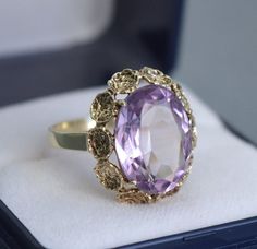 "A beautiful German vintage 8K yellow gold ring decorated with a large natural amethyst gemstone. Size: US 7 3/4, UK P  Ring's head measures 1.8 cm x 1.5 cm (0.7\" x 0.6\"), the amethyst 14 mm x 10 mm Hallmarked: 333 for 8K gold  Weight 3.6 grams Excellent vintage condition The box on the photos for display only! Will be delivered by tracked and signed mail. Thank you for looking. Please see my other items." Antique Urn, Gold Amethyst Ring, Ariana Grande Style, Amethyst Gem, Purple Band, Yellow Gold Ring, Amethyst Gemstone, Amethyst Ring, Yellow Gold Rings