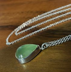 "A tranquil and glowing pear-shaped Prehnite cabochon is set simply into sterling silver and hangs on a 20\" sterling silver chain. Perfect everyday accessory. This one-of-a-kind necklace is ready to ship. Prehnite: 15 x 13mm Chain: 20\" Will arrive gift-boxed. My jewelry is handcrafted one piece at a time by me in my home studio in Portland, Oregon. If I can help you with any questions about this piece or any of my other products, please feel free to contact me: hello@paulla.com PIN IT on PINTE Green Gemstone Necklace, Layered Necklaces Silver, Necklace Green, Everyday Accessories, Layering Necklace, Green Necklace, Green Gemstones, Portland Oregon, Gemstone Necklace