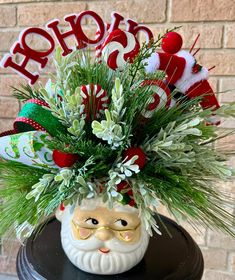 a christmas arrangement in a santa's head vase