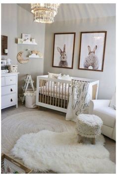 a baby's room with white furniture and pictures on the wall