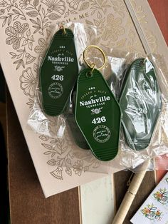 three green keychains sitting on top of a table