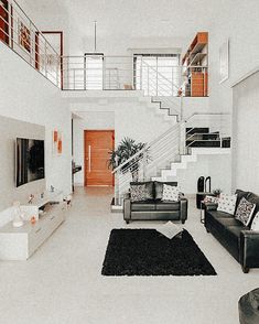 a living room filled with furniture and a stair case