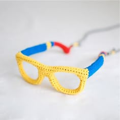 a crocheted yellow and blue eyeglass strap