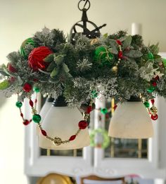 a chandelier with christmas decorations hanging from it