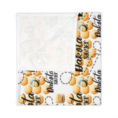 a white bandanna with oranges and the words hello baby on it's side