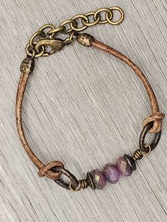 Czech Glass Purple Sapphire Blue Mix beads with antique brass accents on antique brown leather bracelet.  This bracelet has a size fit of approximately 7 inches to 7 1/2 inches. To keep beads, leather and all other components looking their best, avoid contact with water, lotions and perfumes. To access all other items in my shop, just hit the link here: https://www.etsy.com/ca/shop/KootenayLeatherRHS If you like jewelry, check out my other Etsy shop...it's jewelry for your door!  www.etsy.com/ca Adjustable Bohemian Bracelet With Antique Finish, Everyday Brown Jewelry With Waxed Finish, Rustic Jewelry With Leather Strap For Gift, Bohemian Antique Gold Adjustable Bracelets, Rustic Leather Strap Jewelry Gift, Vintage Handmade Bracelets For Everyday Use, Brown Leather Bracelets With Brass Hardware, Rustic Adjustable Bracelet With Waxed Finish, Adjustable Rustic Jewelry With Leather Strap