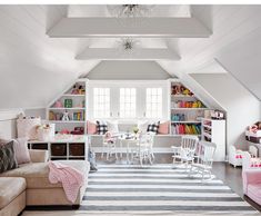 a living room filled with furniture and a white ceiling mounted book shelf next to a window