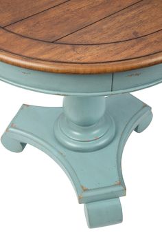 a round wooden table with blue paint and wood trimmings on the top, against a white background