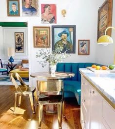 a living room filled with furniture and pictures on the wall above it's dining table