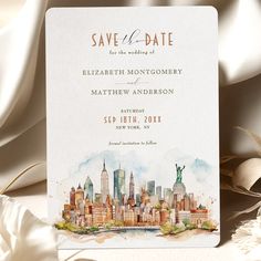 the watercolor skyline save the date card is shown