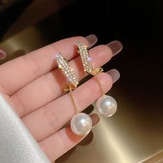 Pearls are the ultimate symbol of sophistication, beauty, and class. Instantly elevate any outfit with these stunning Crystal Erin Pearl Drop Earrings. Gold-plated Artificial white pearl, cubic zirconia crystals Size: 1.8in x 0.5in Pushback stud closure If you aren't in LOVE with your purchase, please let us know within 30 days of receiving your item, and you'll receive a stress-free refund. Pearl Drop Earrings Gold, Fancy Earrings, Pearl Earrings Dangle, Girls Jewelry, Pearl Drop Earrings, Elegant Jewelry, Pearl Drop, White Pearl, Free Jewelry