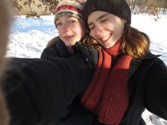 two young women taking a selfie in the snow with their arms around each other