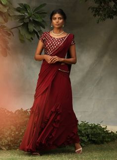 Editor's Note Blouse Is Embellished With Stone Work Maroon Drape Saree Set Fabric: Georgette And Silk Color: Maroon Care: Dry Clean Only About the Designer Nidhika Shekhar Label Is an Exclusive Designer Wear For Women Which Was Launched In 2014. The Label Is A Perfect Amalgamation Of Indian Aesthetics Incorporated In Unique Silhouettes. Their Main Area Of Focus Is Designing Which Fits/suits The Client And They Are Known For The Unique Silhouettes In The Industry. Embellished Georgette Pre-draped Saree For Celebration, Anarkali Style Embellished Georgette Blouse, Traditional Embellished Georgette Blouse, Festive Floor-length Embellished Blouse Piece, Eid Celebration Embellished Blouse Piece, Embellished Blouse Piece For Eid Celebration, Embellished Semi-stitched Blouse With Traditional Drape, Embellished Floor-length Blouse Piece For Festive Occasions, Festive Floor-length Blouse With Mirror Work