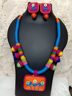 This is a traditional handmade thread necklace with thread pendant and earrings in contrast and multicoloured thread beads. Entire piece is hand crafted. Ideal jewellery for summers. Festive Multicolor Silk Thread Jewelry, Traditional Multicolor Silk Thread Jewelry, Festive Multicolor Beaded Necklace With Latkans, Handmade Traditional Thread Jewelry, Handmade Thread Jewelry For Festive Occasion, Multicolor Beaded Necklaces With Latkans For Festivals, Handmade Multicolor Thread Jewelry, Traditional Multicolor Handloom Jewelry, Bohemian Multicolor Handwork Jewelry