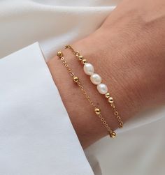 This double row bracelet is delicately made with high quality natural freshwater pearls. Ideal for bringing an elegant and chic style, it is perfect for a gift (wedding, birthday) for someone or for yourself (-: - Details - . Materials: - Freshwater pearl 5×4mm - Gold stainless steel chain - Gold stainless steel clasp . Length of bracelet: 15.5cm plus a 4cm extension chain. . The chain and lobster clasp allow the bracelet to be perfectly adjusted to the size of the wrist (wrist circumference from 14cm to 18cm). If you want another size, do not hesitate to leave me a message to tell me the desired length. . The bracelet is sent (by registered letter) with an organza bag. If you mark the order as a gift, I will put the bracelet in a gift bag closed with a sticker before posting it. . The sto Luxury Classic Beaded Bracelets With Pearl Chain, Elegant Pearl Bracelet With Delicate Chain, Elegant Pearl Chain Bracelet As Gift, Elegant Pearl Drop Chain Bracelet Gift, Elegant Pearl Bracelets With Delicate Chain, Elegant Gold Beaded Bracelets With Delicate Chain, Elegant Pearl Bracelet With Delicate Chain As Gift, Delicate Gold Chain Bracelet With Pearls, Elegant White Chain Bracelet With Pearl Drop