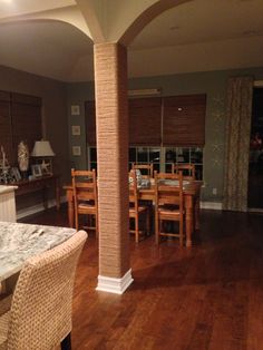 a dining room and kitchen area with wood floors