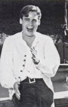 an old black and white photo of a man laughing