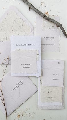 the wedding stationery is laid out on top of each other